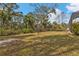 Spacious backyard with a screened enclosure and lush landscaping at 5547 Wagon Wheel Dr, North Port, FL 34291