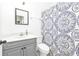 Clean bathroom with gray vanity and patterned shower curtain at 5547 Wagon Wheel Dr, North Port, FL 34291