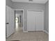 Bright bedroom with tile floors and double door closet at 5547 Wagon Wheel Dr, North Port, FL 34291