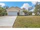 Single-story house with a two-car garage and a well-manicured lawn at 5547 Wagon Wheel Dr, North Port, FL 34291