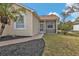 Side view of a house with a screened porch and walkway at 5547 Wagon Wheel Dr, North Port, FL 34291