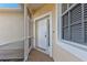 White front door with sidelights and a screened porch at 5547 Wagon Wheel Dr, North Port, FL 34291