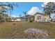 Tan house exterior with a screened patio and a large backyard at 5547 Wagon Wheel Dr, North Port, FL 34291