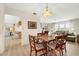 Casual dining area with light wood floors and adjacent kitchen at 625 Via Tunis, Punta Gorda, FL 33950