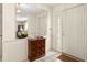 Bright entryway with tiled floors, wood cabinet, and mirror at 625 Via Tunis, Punta Gorda, FL 33950