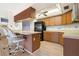 Galley kitchen with wood cabinets and breakfast bar at 625 Via Tunis, Punta Gorda, FL 33950