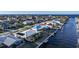 Aerial view showcasing a waterfront home with private dock and neighborhood context at 66 Ocean Dr, Punta Gorda, FL 33950