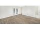 Spacious bedroom with French doors and wood-look tile floors at 66 Ocean Dr, Punta Gorda, FL 33950