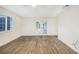 Bright bedroom with wood-look tile flooring and plantation shutters at 66 Ocean Dr, Punta Gorda, FL 33950