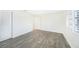 Bright bedroom with wood-look tile flooring and window with shutters at 66 Ocean Dr, Punta Gorda, FL 33950