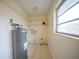 Laundry room with shelving, water heater, and window at 66 Ocean Dr, Punta Gorda, FL 33950