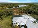 Aerial view of a home showcasing its metal roof and waterfront access at 700 N River Rd, Venice, FL 34293