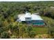 Bird's-eye view of the house, pool, and tropical landscaping at 700 N River Rd, Venice, FL 34293