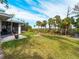 Landscaped backyard with lush lawn and tropical foliage at 700 N River Rd, Venice, FL 34293