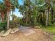 Beautiful backyard with a boardwalk that leads to a charming walkway through a lush garden at 700 N River Rd, Venice, FL 34293