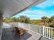 Relaxing balcony with outdoor seating offering beautiful views of the tropical landscape and sky at 700 N River Rd, Venice, FL 34293