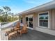 Balcony with ample seating provides an ideal spot for enjoying fresh air and nature views from your home at 700 N River Rd, Venice, FL 34293