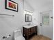 Bathroom featuring vanity with a white countertop and a door leading outside at 700 N River Rd, Venice, FL 34293