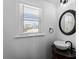 Bathroom featuring vessel sink, elegant mirror, and window at 700 N River Rd, Venice, FL 34293