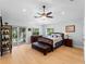 Bright bedroom with light wood floors and a ceiling fan at 700 N River Rd, Venice, FL 34293