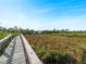 Wooden boardwalk path over marshy landscape at 700 N River Rd, Venice, FL 34293