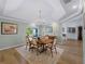 Traditional dining room with a chandelier, ample natural light, and wood flooring at 700 N River Rd, Venice, FL 34293