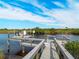 Private boat dock featuring a covered boat lift and a wooden walkway, perfect for waterfront living and enjoying the serene views at 700 N River Rd, Venice, FL 34293