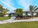 House exterior with metal roof and tropical landscaping at 700 N River Rd, Venice, FL 34293