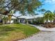 House exterior with metal roof and tropical landscaping at 700 N River Rd, Venice, FL 34293