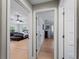 Hallway view displaying hardwood floors and open doors into bedrooms at 700 N River Rd, Venice, FL 34293