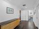 Hallway with decorative molding, wood floors and natural light at 700 N River Rd, Venice, FL 34293