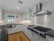 Modern kitchen features stainless steel appliances and white cabinetry at 700 N River Rd, Venice, FL 34293