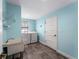 Bright laundry room with washer, dryer, utility sink, and ample shelving at 700 N River Rd, Venice, FL 34293