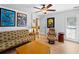 Cozy living room featuring hardwood floors, ceiling fan and unique decorative items at 700 N River Rd, Venice, FL 34293