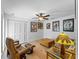 Relaxing living room with hardwood floors, ceiling fan and unique decorative items at 700 N River Rd, Venice, FL 34293