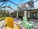 Outdoor entertaining area with colorful chairs and a built-in grill offers a perfect space to relax with friends and Gathering at 700 N River Rd, Venice, FL 34293