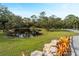 Scenic pond surrounded by trees and lush greenery, creating a tranquil backyard oasis at 700 N River Rd, Venice, FL 34293