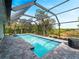 Screen enclosed pool with stone patio, screened enclosure and natural views at 700 N River Rd, Venice, FL 34293