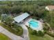 Aerial view of a stunning pool with a hot tub and plenty of space for outdoor entertaining at 700 N River Rd, Venice, FL 34293