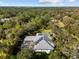 Aerial view of house with pool and solar panels on the roof at 7563 Albert Tillinghast Dr, Sarasota, FL 34240