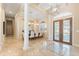 Elegant entryway with columns, tiled floors, and double doors at 7563 Albert Tillinghast Dr, Sarasota, FL 34240