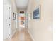 Bright hallway with tile flooring and access to other rooms at 7563 Albert Tillinghast Dr, Sarasota, FL 34240