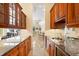 Kitchen features granite countertops and wooden cabinets at 7563 Albert Tillinghast Dr, Sarasota, FL 34240