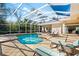 Resort style screened pool and spa with plenty of seating at 7563 Albert Tillinghast Dr, Sarasota, FL 34240