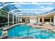 Inviting pool area with covered patio and lounge chairs at 7563 Albert Tillinghast Dr, Sarasota, FL 34240