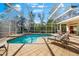 Relaxing pool and spa area with a screened enclosure at 7563 Albert Tillinghast Dr, Sarasota, FL 34240