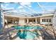 Spacious screened pool and spa with plenty of lounge chairs at 7563 Albert Tillinghast Dr, Sarasota, FL 34240