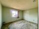 Well-lit bedroom with window, carpet, and closet at 7570 Berwick St, North Port, FL 34287