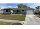 House with a gray roof, light blue exterior, and a driveway at 7570 Berwick St, North Port, FL 34287