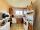 Galley-style kitchen with wood cabinets and stainless steel appliances at 7570 Berwick St, North Port, FL 34287